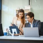 a businessman and woman sit at a modern office tab 2026 01 08 01 27 35 utc