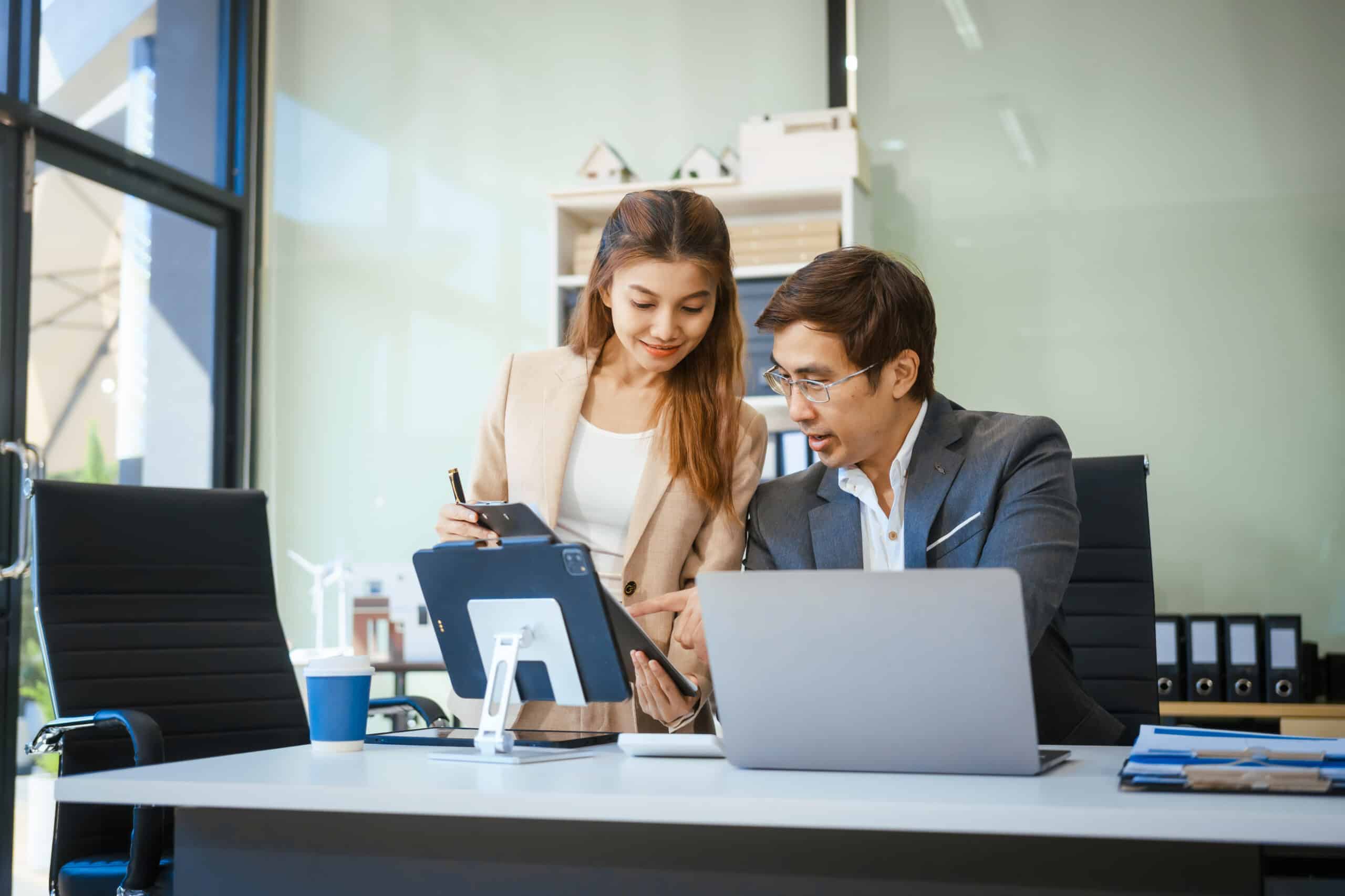 a businessman and woman sit at a modern office tab 2026 01 08 01 27 35 utc scaled