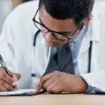 healthcare professional filling out a therapy superbill template