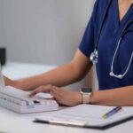 medical professional using a detox center software on computer