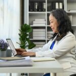 therapist using a mental health EHR to document her work