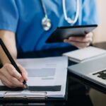 medical professional working with tablet and paper 2026 09 21 02 21 11 utc 1